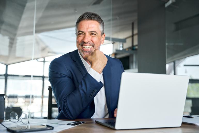 Gerente sonriendo frente a un computador